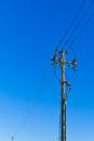 electric power sky lines and connections on a wooden post. wooden electricity post against blue sky. Electric power lines and Royalty Free Stock Photo