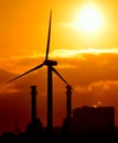 Electric power station and wind turbine at sunrise
