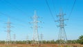 Electric power transmission on the background of blue sky. Technogenic landscape. Transmission tower or an electricity pylon