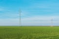 Electric power transmission, electricity power line pylons in countryside fields