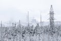 An electric power transmission lines from power station passes in wintry forest, snowy wires Royalty Free Stock Photo