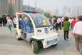 Electric police car parked near crowds