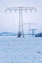 Electric power lines with wind turbines in winter landscape, germany, thuringia, jena