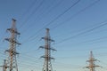 Electric powerlines. High voltage power lines, pylons against blue sky Royalty Free Stock Photo