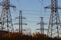 Electric powerlines. High voltage power lines, pylons on blue sky background