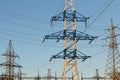 Electric powerlines. High voltage power lines, pylons on blue sky background