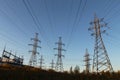 Electric powerlines on electric substation and distribution power. High voltage power lines, pylons against blue sky Royalty Free Stock Photo