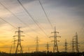 Electric pylons with cables and wires at dawn or dusk.