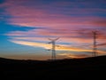 Electric pylons on a sunset with beautiful clouds