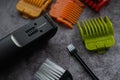 Electric razor with different heads on concrete background. Tool for beard trimming. Close up view Royalty Free Stock Photo