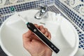 Electric Rechargeable Toothbrush with a Black Handle and Toothbrush Heads