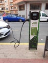 Electric Renault car connected to a public charging point in the street