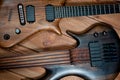 Electric rhythm guitar and five-string bass photographed on a wooden surface