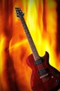 Electric rock guitar on a fire background. Royalty Free Stock Photo