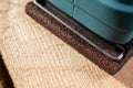 electric sander machine over wood. construction carpentry concept. Royalty Free Stock Photo
