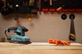 electric sander machine standing on workbench in carpentry workshop Royalty Free Stock Photo