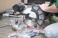 Electric Saw in worker hands. A circular saw cutting wooden beam
