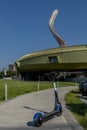 An electric scooter with the Luigi Pecci Center for Contemporary Art in the background, Prato, Italy Royalty Free Stock Photo