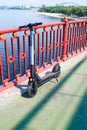 Electric scooter on the pedestrian bridge. Electric scooter rental for walking. Close-up photo. The river is in the background