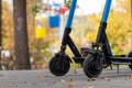 Electric Scooters in autumn park with cableway