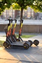 Electric scooters in a public parking lot on a city street or park on sunny summer day. Rent of modern eco-friendly transport, Royalty Free Stock Photo