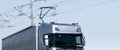 Electric semi truck with pantograph takes energy from wires above the highway