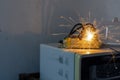 An electric shork from a microwave outlet causes a spark. Dangerous concept of using old electrical appliances and without quality Royalty Free Stock Photo