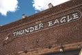 Electric signboard on brick wall at entrance of store with sky in background Royalty Free Stock Photo