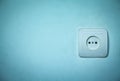 Electric socket on a blue wall. Royalty Free Stock Photo