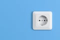 Electric socket on blue wall Royalty Free Stock Photo