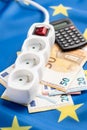 Electric socket and euro money on european union flag. Concept of energy crisis Royalty Free Stock Photo