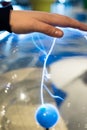 Electric sphere produce plasma with blue sparks and bolt. Science education experiment with electricity and plasma ball. Science