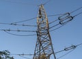 Electric station for supplying electricity to city, village. High voltage electric tower. Close-up. Power line against blue sky Royalty Free Stock Photo