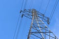Electric station for supplying electricity to city, village. High voltage electric tower. Close-up. Power line against blue sky Royalty Free Stock Photo