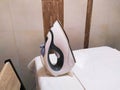 Electric steam iron on the table