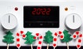 2022 on electric stove timer with Xmas decorations, festive symbols for restaurant or home cooking on New Year holidays