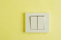 Electric switch with space for text on yellow wall. Royalty Free Stock Photo