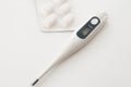 Electric thermometer and pills.