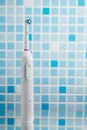 Electric toothbrush on blue tile background Royalty Free Stock Photo