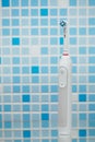 Electric toothbrush on blue tile background Royalty Free Stock Photo