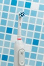 Electric toothbrush on blue tile background Royalty Free Stock Photo