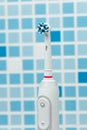 Electric toothbrush on blue tile background Royalty Free Stock Photo