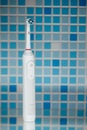 Electric toothbrush on blue tile background Royalty Free Stock Photo