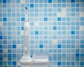 Electric toothbrush on blue tile background Royalty Free Stock Photo