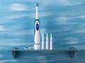 Electric toothbrush with colored tips on the glass shelf