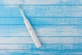 Electric Toothbrush On Fresh High Contrast Scratched Blue And White Painted Wood Background Top Angle Royalty Free Stock Photo
