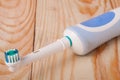 Electric Toothbrush on a light wooden background Royalty Free Stock Photo