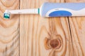 Electric Toothbrush on a light wooden background Royalty Free Stock Photo