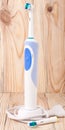 Electric Toothbrush on a light wooden background Royalty Free Stock Photo