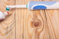 Electric Toothbrush on a light wooden background Royalty Free Stock Photo